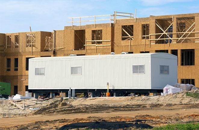 workers studying blueprints in a temporary rental office in Cypress